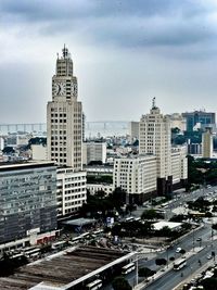 Skyscrapers against cloudy sky