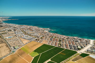 High angle view of sea against clear blue sky