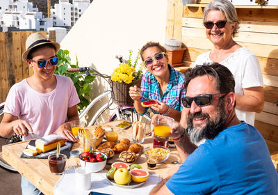 Portrait of family having food on table