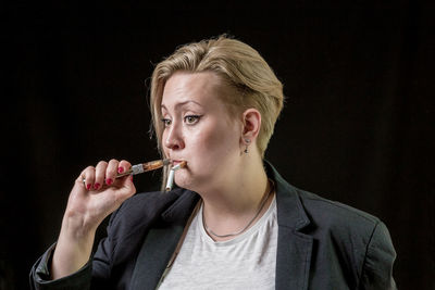 Portrait of mid adult man against black background