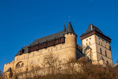 Low angle view of building against clear blue sky