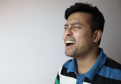 Portrait of young man against white background