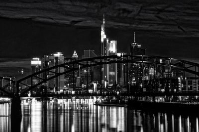 Modern city skyline against sky at night