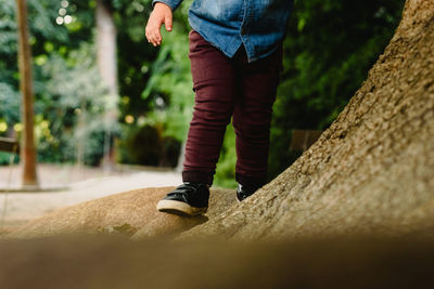 Low section of boy standing on rock