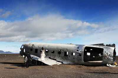 Abandoned airplane on runway against sky