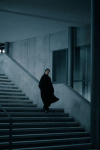 Full length of woman standing on staircase