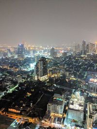 High angle view of illuminated city buildings against sky
