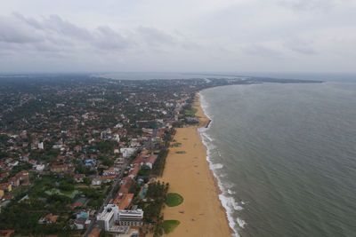 High angle view of sea and buildings against sky