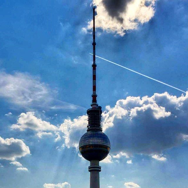 communications tower, sky, low angle view, cloud - sky, built structure, tower, architecture, television tower, tall - high, fernsehturm, spire, communication, building exterior, cloud, culture, sphere, international landmark, cloudy, travel destinations, blue
