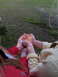 Midsection of woman with hands on field