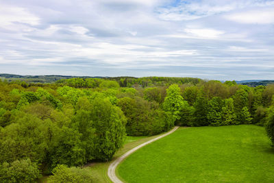 Scenic view of green landscape against sky