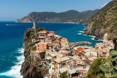 High angle view of townscape by sea against sky