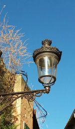 Low angle view of street light against clear blue sky