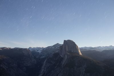 Scenic view of mountains against sky at night