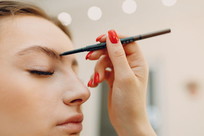 Close-up of woman applying nail polish