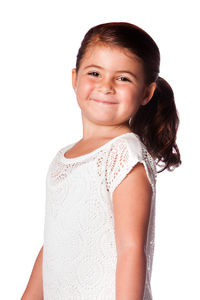 Close-up portrait of smiling girl against white background
