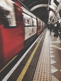 Blurred motion of train at railroad station