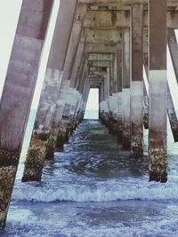 View of pier over sea against buildings