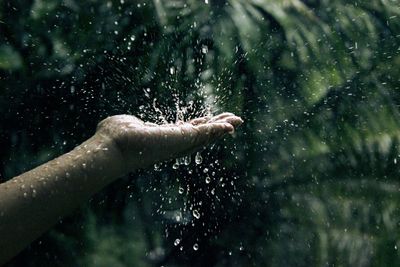 Close-up of hand on wet glass