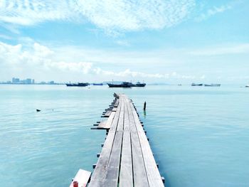 Pier over sea against sky