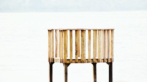 Wooden posts on beach against sea