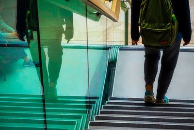 Low section of man standing by swimming pool