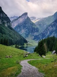 Scenic view of lake by mountains against sky