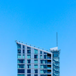 Low angle view of building against clear blue sky