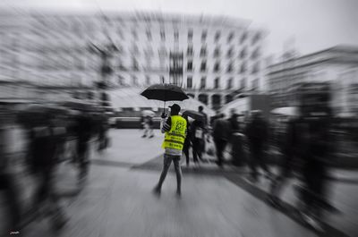 Blurred motion of man with umbrella