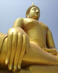 Low angle view of buddha statue against clear sky