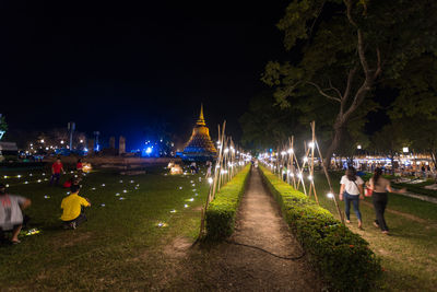 People on illuminated city at night