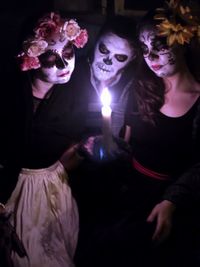 Midsection of woman looking at illuminated halloween