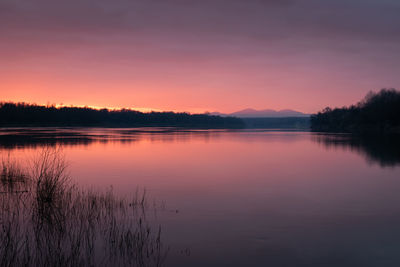 Scenic view of lake against sky during sunset
