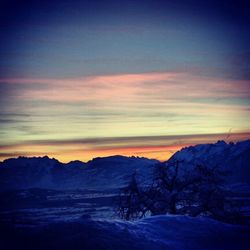 Scenic view of snow covered mountains against sky