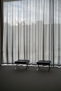 Two chairs in front of a curtain inside neue nationalgalerie, berlin 
