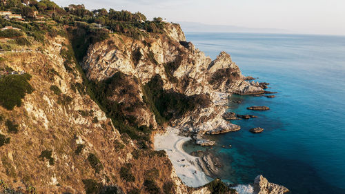 Cliff on the turquoise sea at sunset