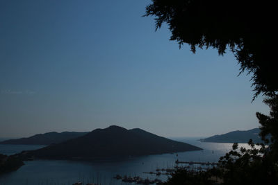 Scenic view of sea against clear blue sky at dusk