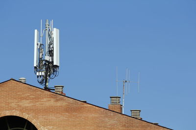 Low angle view of communications tower against clear sky