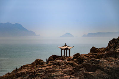 Scenic view of sea and mountains against sky