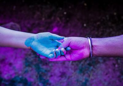Close-up of hands holding purple hand