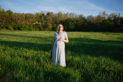 Full length of woman standing on field