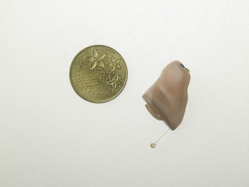 High angle view of coins on white background