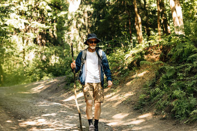 Portrait of man standing on road