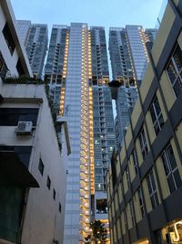 Low angle view of modern buildings in city against sky