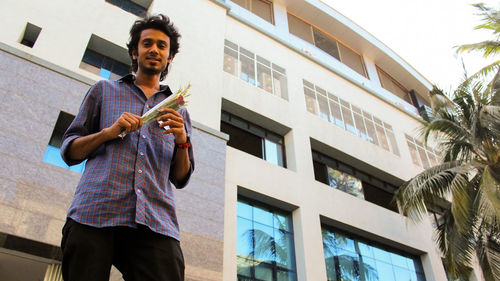 Low angle view of man standing against building