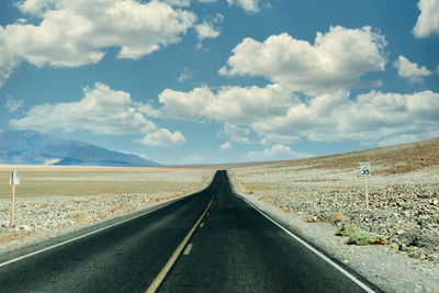 Empty road along countryside landscape