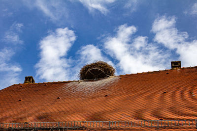 Low angle view of building roof against sky