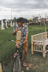 Boy riding bicycle on field