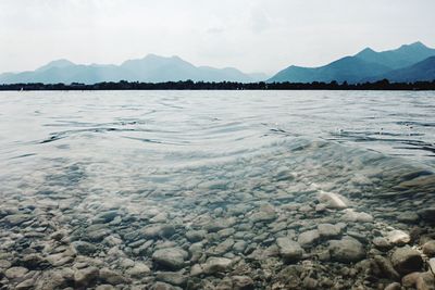 Scenic view of sea and mountains against sky