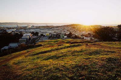 Scenic view of field against clear sky during sunset